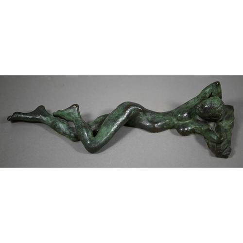 856 - Charlotte Jackson - A verdigris patinated bronze sculpture of a reclining woman, 42 cm long