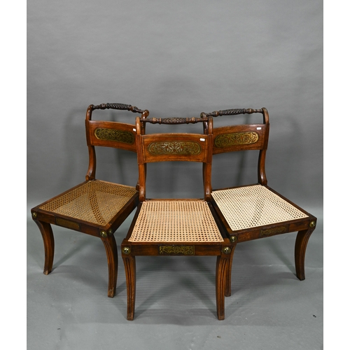 863 - A set of five Regency brass inlaid mahogany caned seat side chairs with sabre front legs to/w four o... 