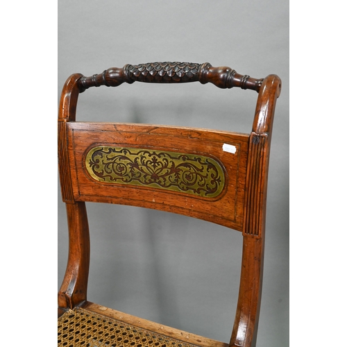 863 - A set of five Regency brass inlaid mahogany caned seat side chairs with sabre front legs to/w four o... 