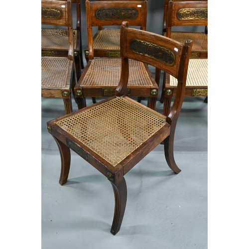 863 - A set of five Regency brass inlaid mahogany caned seat side chairs with sabre front legs to/w four o... 