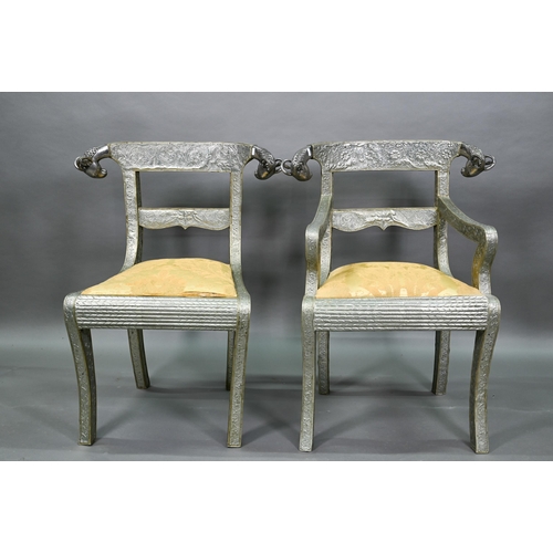 865 - A pair of Indian metal clad dining hall chairs, with rams head back terminals over sabre front legs ... 