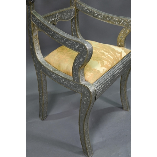 865 - A pair of Indian metal clad dining hall chairs, with rams head back terminals over sabre front legs ... 