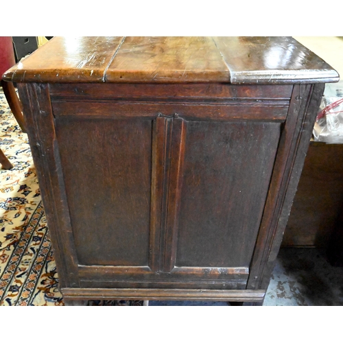 867 - A very large early 18th century oak coffer, the three plank top over a moulded frieze and four panel... 