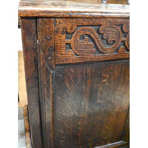 867 - A very large early 18th century oak coffer, the three plank top over a moulded frieze and four panel... 