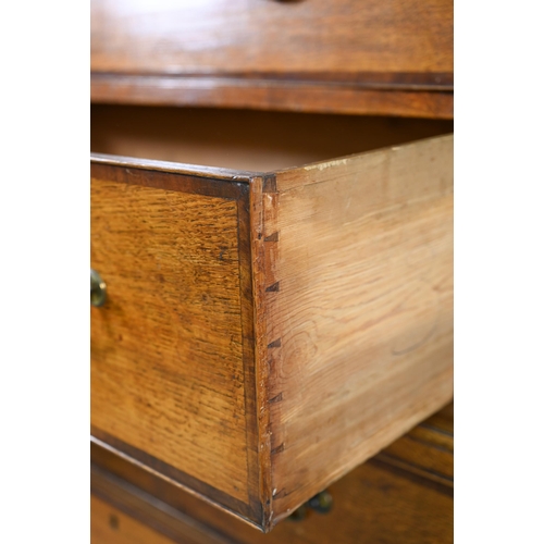 870 - A George III cross-banded oak chest on chest, the moulded cornice with inlaid boxwood roundels, over... 