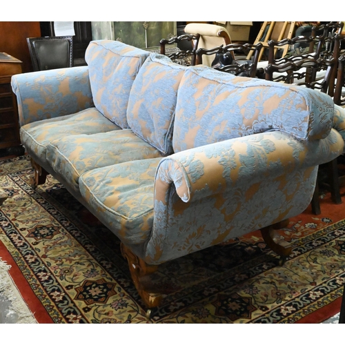 873 - An walnut and upholstered three-seat sofa with blue and brown/gold upholstery / cushions, raised on ... 