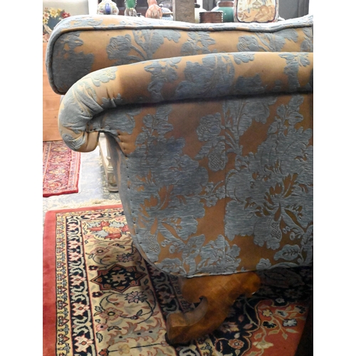 873 - An walnut and upholstered three-seat sofa with blue and brown/gold upholstery / cushions, raised on ... 