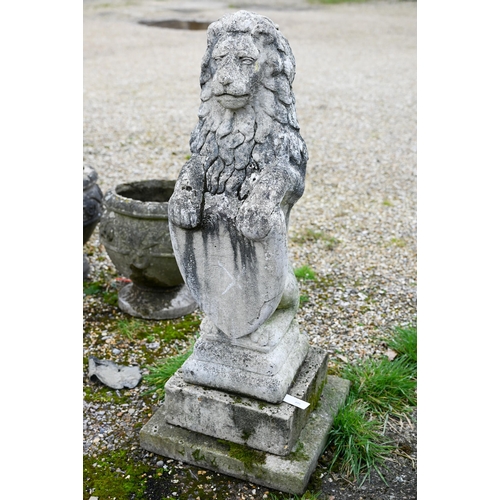 895 - A weathered cast stone armorial standing lion with shield, raised on a stepped a square base, 98 cm ... 