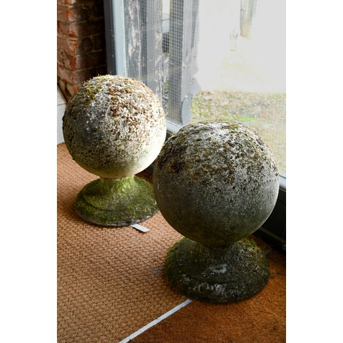 898 - A large pair of weathered old cast stone ball finials, 37 cm dia. raised on circular socle bases, 50... 