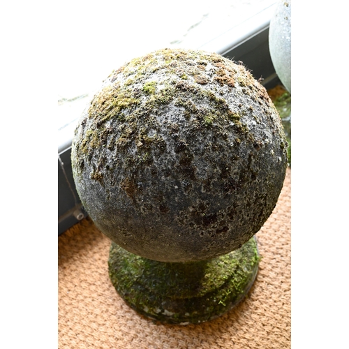 898 - A large pair of weathered old cast stone ball finials, 37 cm dia. raised on circular socle bases, 50... 