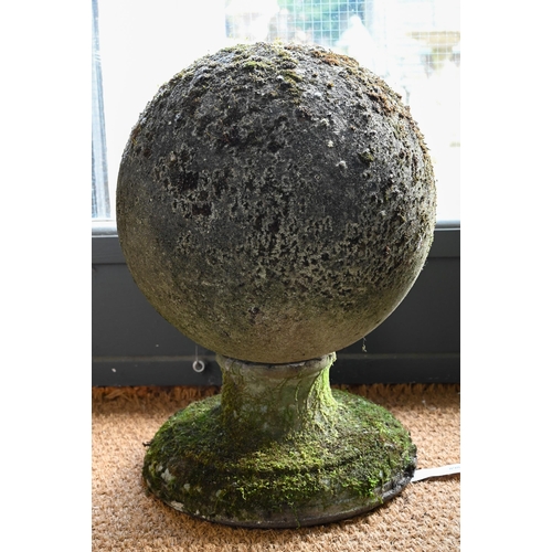 898 - A large pair of weathered old cast stone ball finials, 37 cm dia. raised on circular socle bases, 50... 