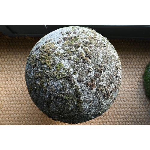 898 - A large pair of weathered old cast stone ball finials, 37 cm dia. raised on circular socle bases, 50... 