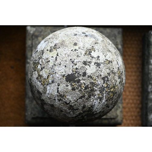 899 - A pair of large weathered old cast stone spherical finials, raised on square socle bases, 40 cm x 40... 