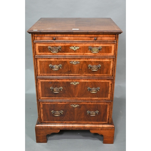 907 - A well executed Georgian style small cross and feather-banded walnut chest of four drawers beneath a... 