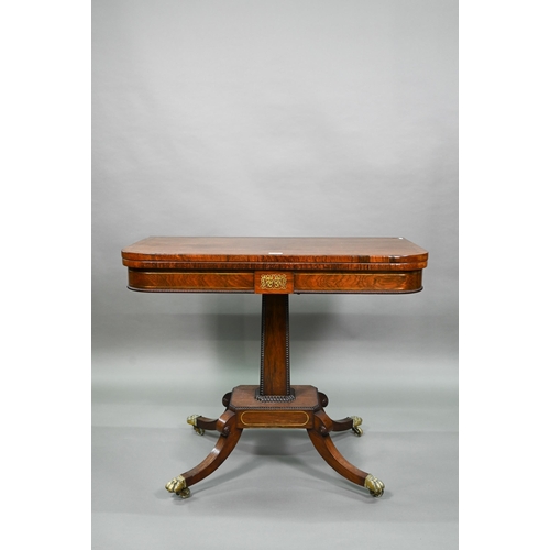 909 - A Regency brass inlaid rosewood card table, the fold over top with baize lined interior, raised on a... 