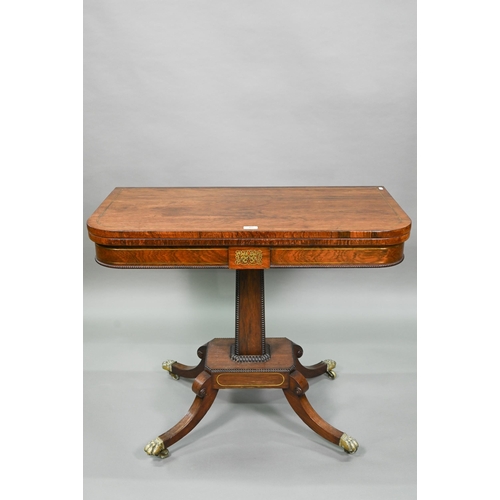 909 - A Regency brass inlaid rosewood card table, the fold over top with baize lined interior, raised on a... 