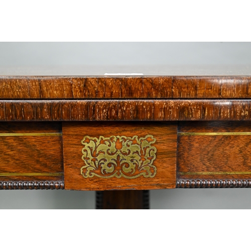 909 - A Regency brass inlaid rosewood card table, the fold over top with baize lined interior, raised on a... 