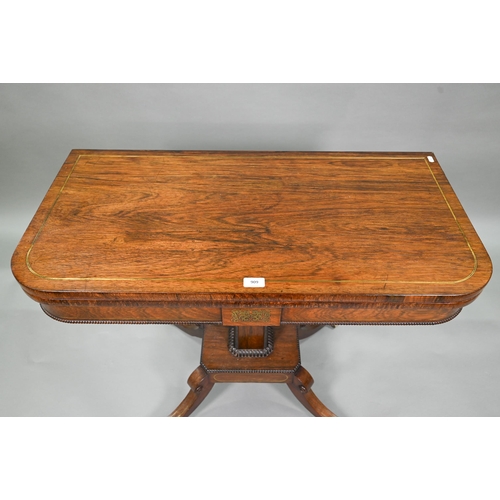 909 - A Regency brass inlaid rosewood card table, the fold over top with baize lined interior, raised on a... 