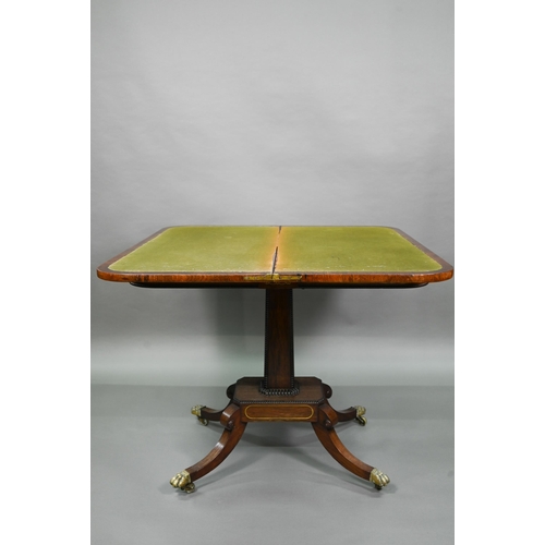 909 - A Regency brass inlaid rosewood card table, the fold over top with baize lined interior, raised on a... 