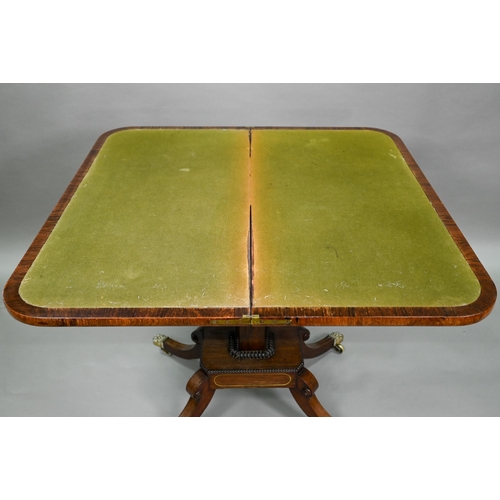 909 - A Regency brass inlaid rosewood card table, the fold over top with baize lined interior, raised on a... 