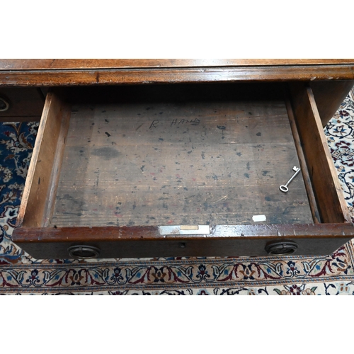 913 - A 19th century mahogany library table, the silver tooled burgundy leather inset top over a pair of f... 