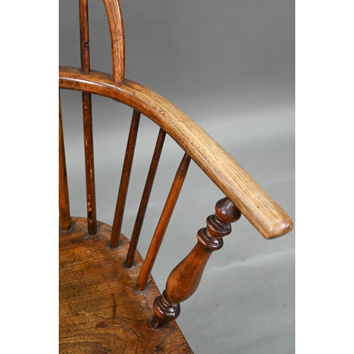 918 - An old Windsor elbow chair with elm seat and raised over a crinoline stretcher