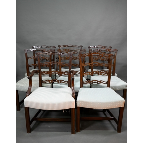 922 - A set of eight Georgian style walnut dining chairs with pierced wavy splats over overstuffed seats o... 