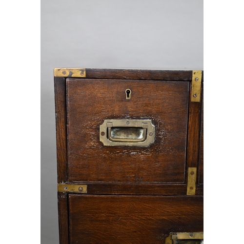 924 - A Victorian brass bound teak campaign secretaire chest, in two parts, centred by a fitted fall front... 