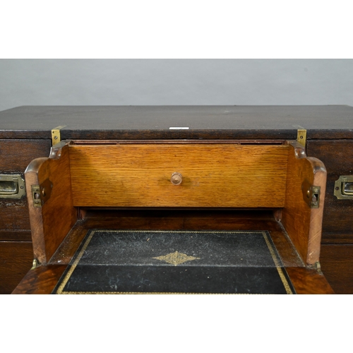 924 - A Victorian brass bound teak campaign secretaire chest, in two parts, centred by a fitted fall front... 