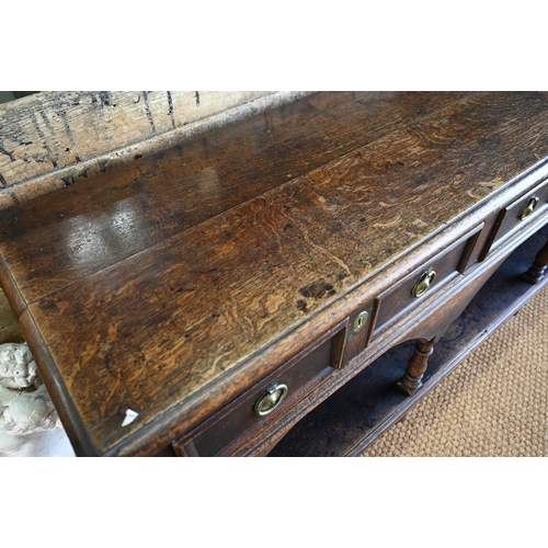 925 - An antique oak low dresser with three double moulded front drawers over a triple arched apron, raise... 