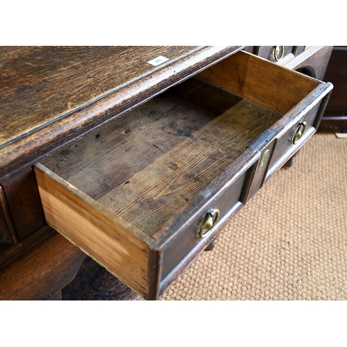 925 - An antique oak low dresser with three double moulded front drawers over a triple arched apron, raise... 