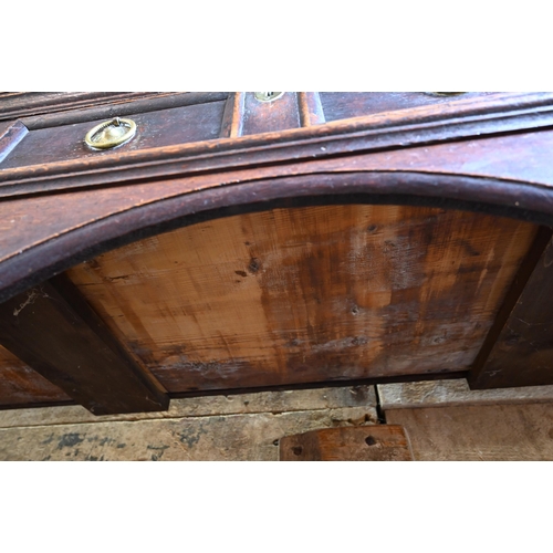 925 - An antique oak low dresser with three double moulded front drawers over a triple arched apron, raise... 