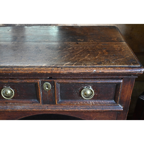 925 - An antique oak low dresser with three double moulded front drawers over a triple arched apron, raise... 