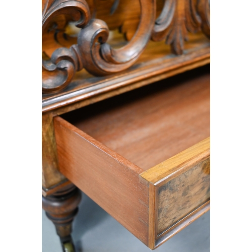 926 - A late Victorian walnut Canterbury, the four moulded and fret cut divisions over a base drawer, on b... 