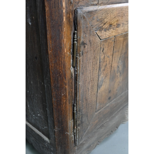 928 - An antique provincial French oak cupboard, Normandy, with three drawers over a pair of mitre framed ... 