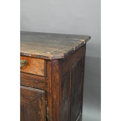 928 - An antique provincial French oak cupboard, Normandy, with three drawers over a pair of mitre framed ... 