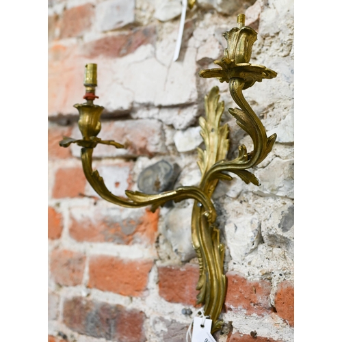 931 - A pair of Rococo style two branch ormolu wall sconces, 42 cm h, bright but tarnished, one arm missha... 