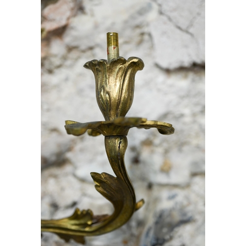 931 - A pair of Rococo style two branch ormolu wall sconces, 42 cm h, bright but tarnished, one arm missha... 