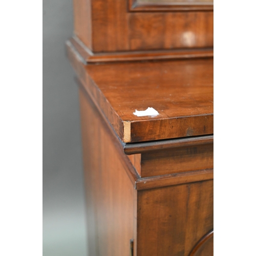 933 - A late Victorian mahogany library cabinet bookcase, the pair of arched glazed doors over a conformin... 