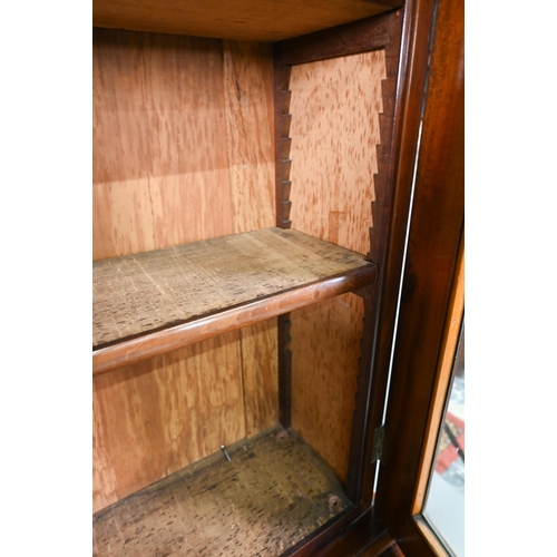 933 - A late Victorian mahogany library cabinet bookcase, the pair of arched glazed doors over a conformin... 