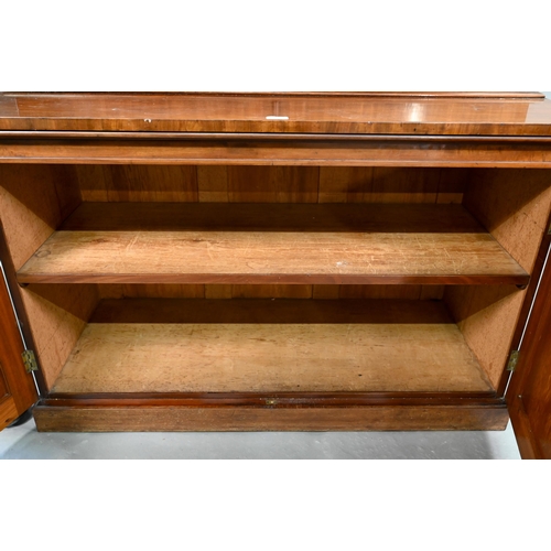 933 - A late Victorian mahogany library cabinet bookcase, the pair of arched glazed doors over a conformin... 