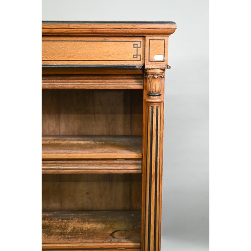 938 - A Victorian Gothic revival period oak and birch low open bookcase, the inverted breakfront top over ... 