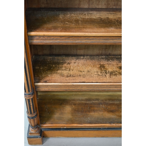 938 - A Victorian Gothic revival period oak and birch low open bookcase, the inverted breakfront top over ... 