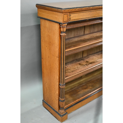 938 - A Victorian Gothic revival period oak and birch low open bookcase, the inverted breakfront top over ... 