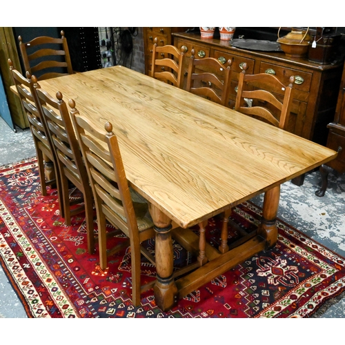 939 - A 17th century golden oak refectory table with baluster turned supports united by a centre stretcher... 