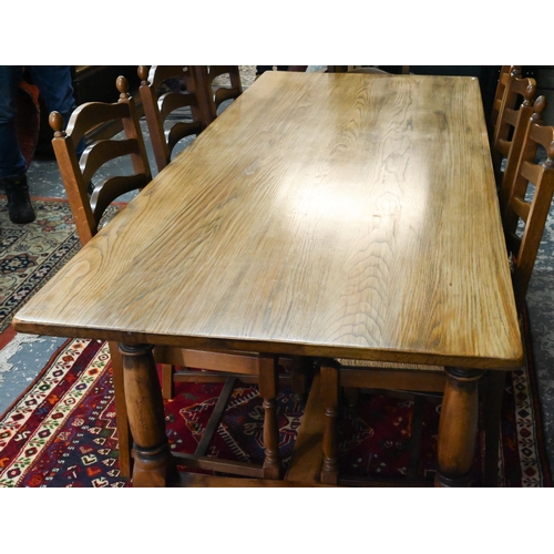 939 - A 17th century golden oak refectory table with baluster turned supports united by a centre stretcher... 