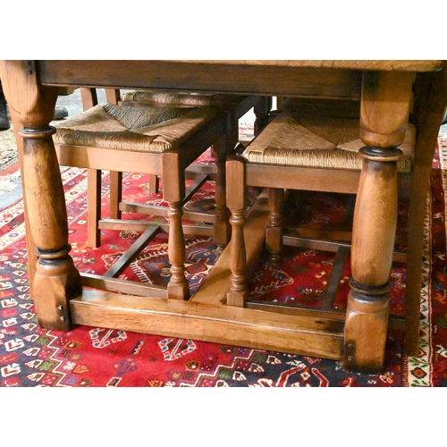 939 - A 17th century golden oak refectory table with baluster turned supports united by a centre stretcher... 