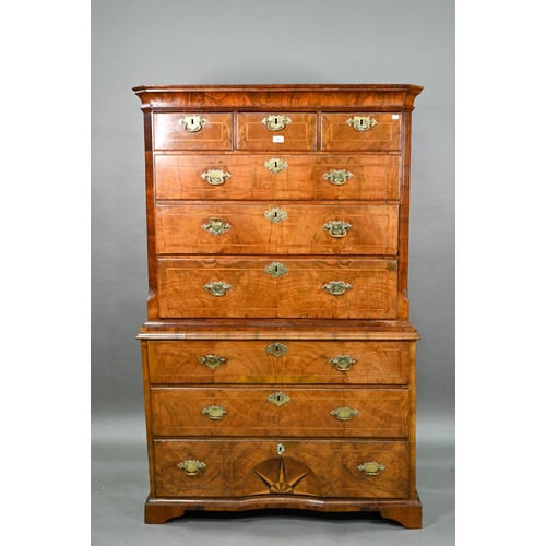 943 - An 18th century feather-banded chest on chest. the moulded cornice over three short and six long gra...