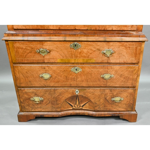 943 - An 18th century feather-banded chest on chest. the moulded cornice over three short and six long gra... 