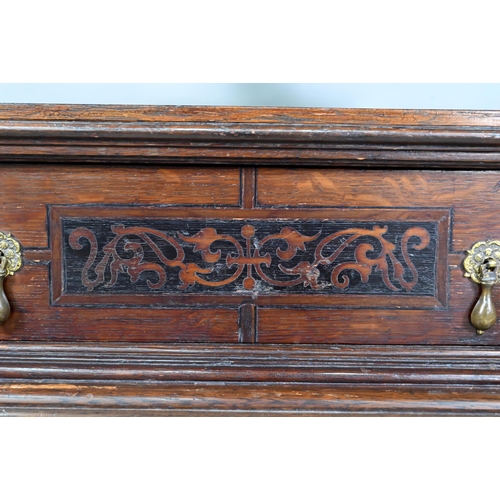 946 - An antique oak, walnut and marquetry book press, with two frieze drawers, raised on four bulbous sup... 